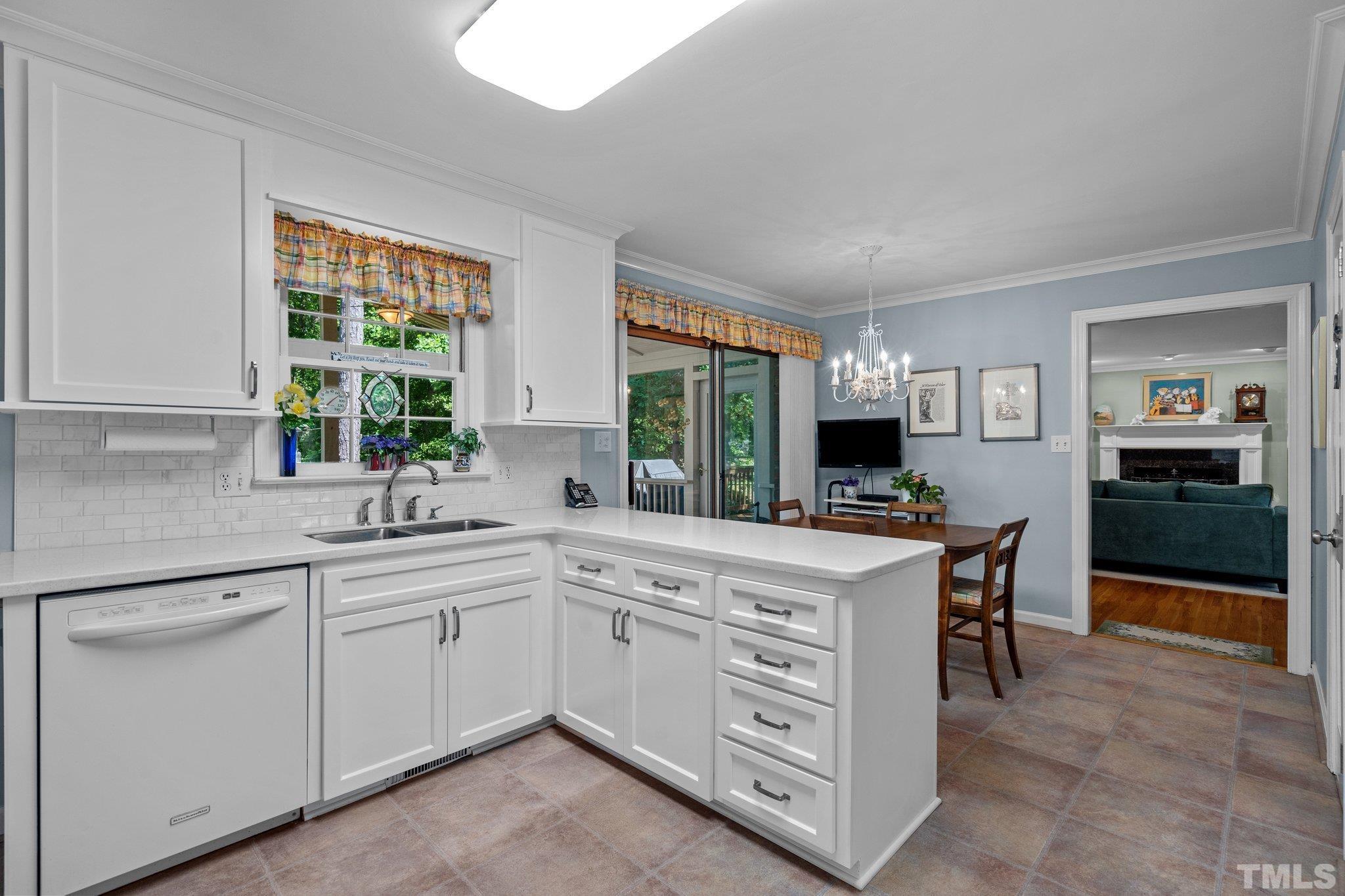 7805 Harps Mill Road Raleigh, NC 27615 - Photo 20 of 57 a kitchen with a stove top oven sink and cabinets