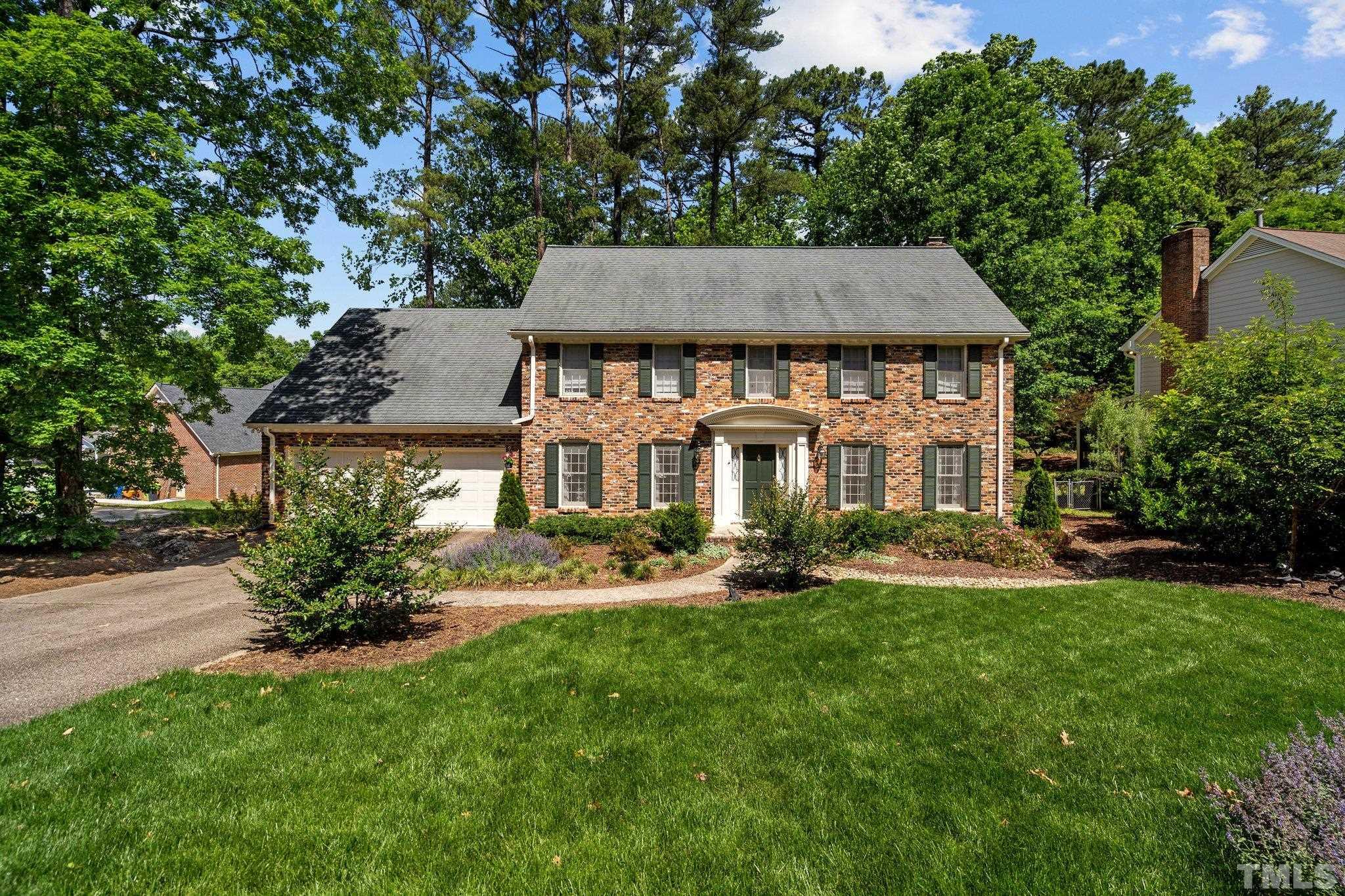 7805 Harps Mill Road Raleigh, NC 27615 - Photo 2 of 57 a view of a house with a yard and sitting area