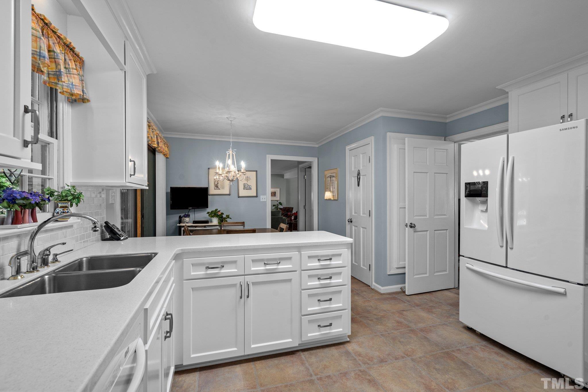 7805 Harps Mill Road Raleigh, NC 27615 - Photo 21 of 57 a kitchen with appliances a sink and cabinets