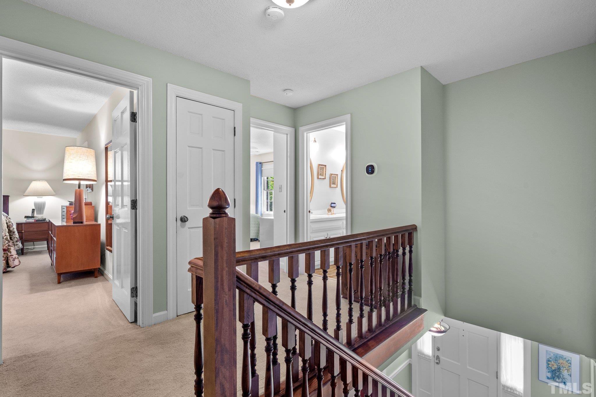 7805 Harps Mill Road Raleigh, NC 27615 - Photo 26 of 57 a view of a hallway to a livingroom with furniture and windows