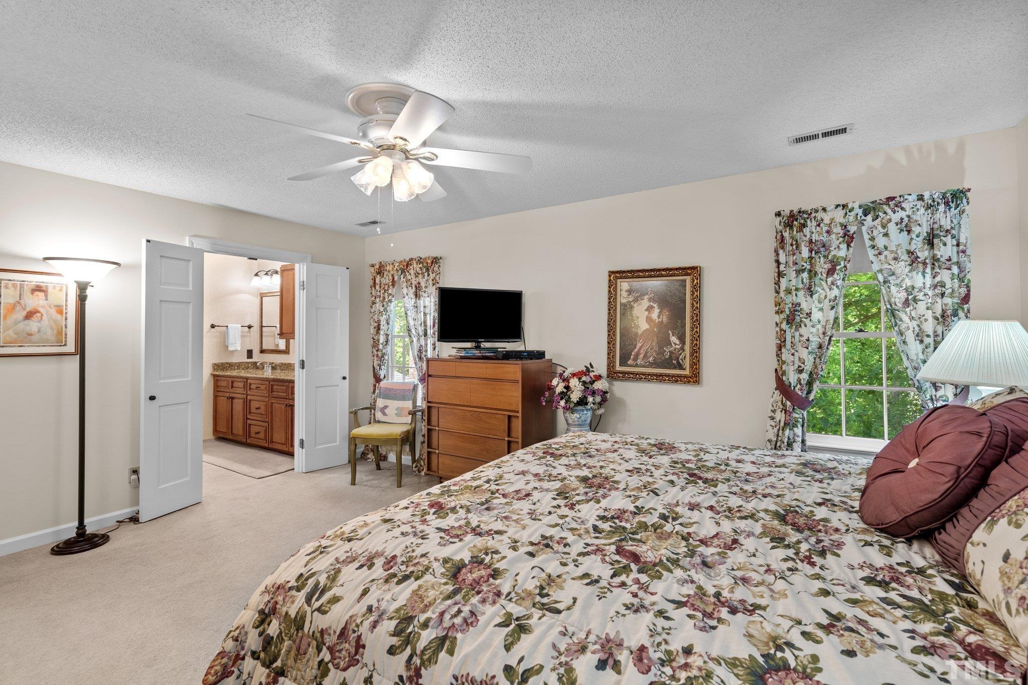 7805 Harps Mill Road Raleigh, NC 27615 - Photo 29 of 57 a bed room with a bed and a television