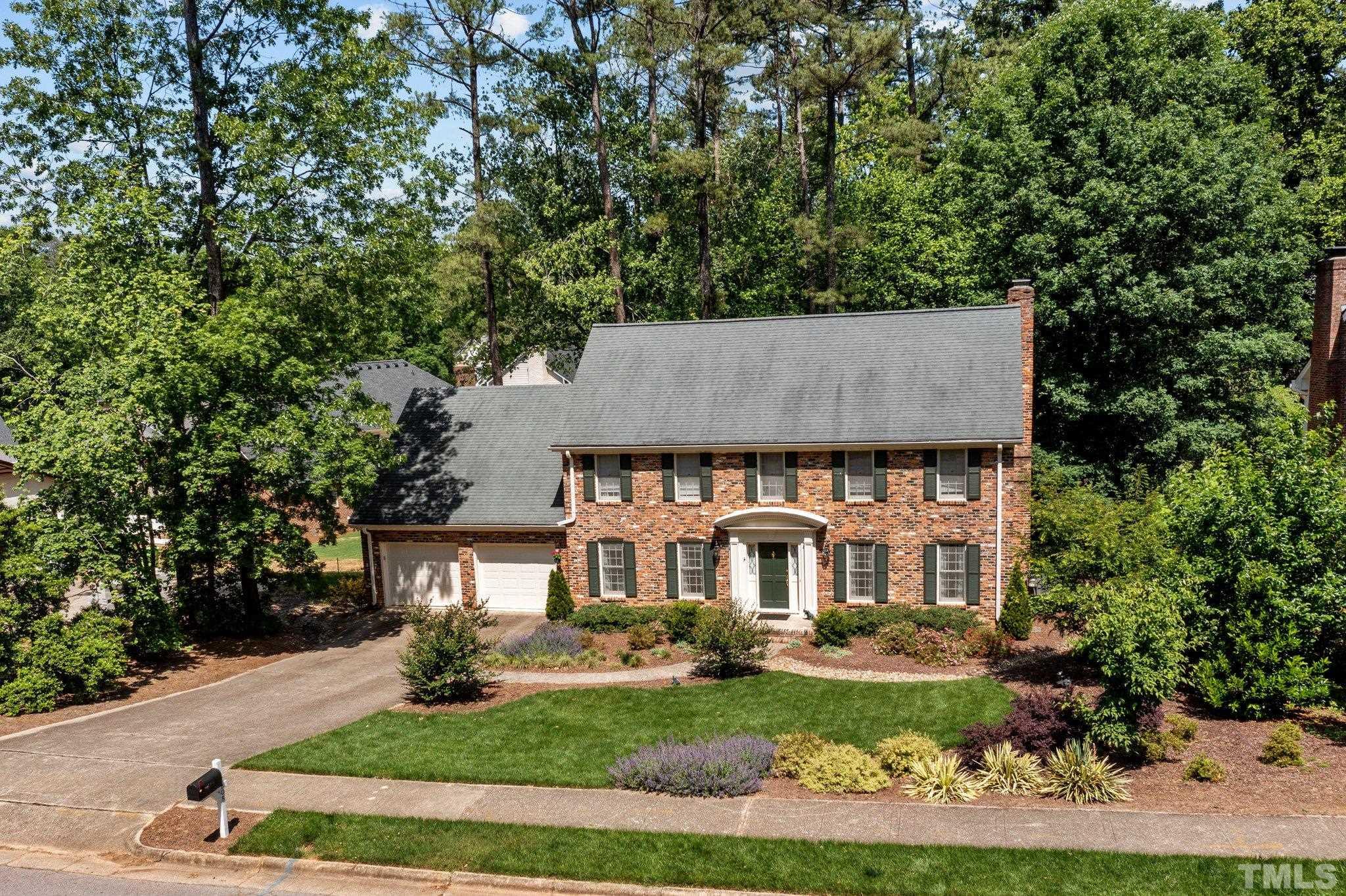 7805 Harps Mill Road Raleigh, NC 27615 - Photo 3 of 57 front view of a house with a yard
