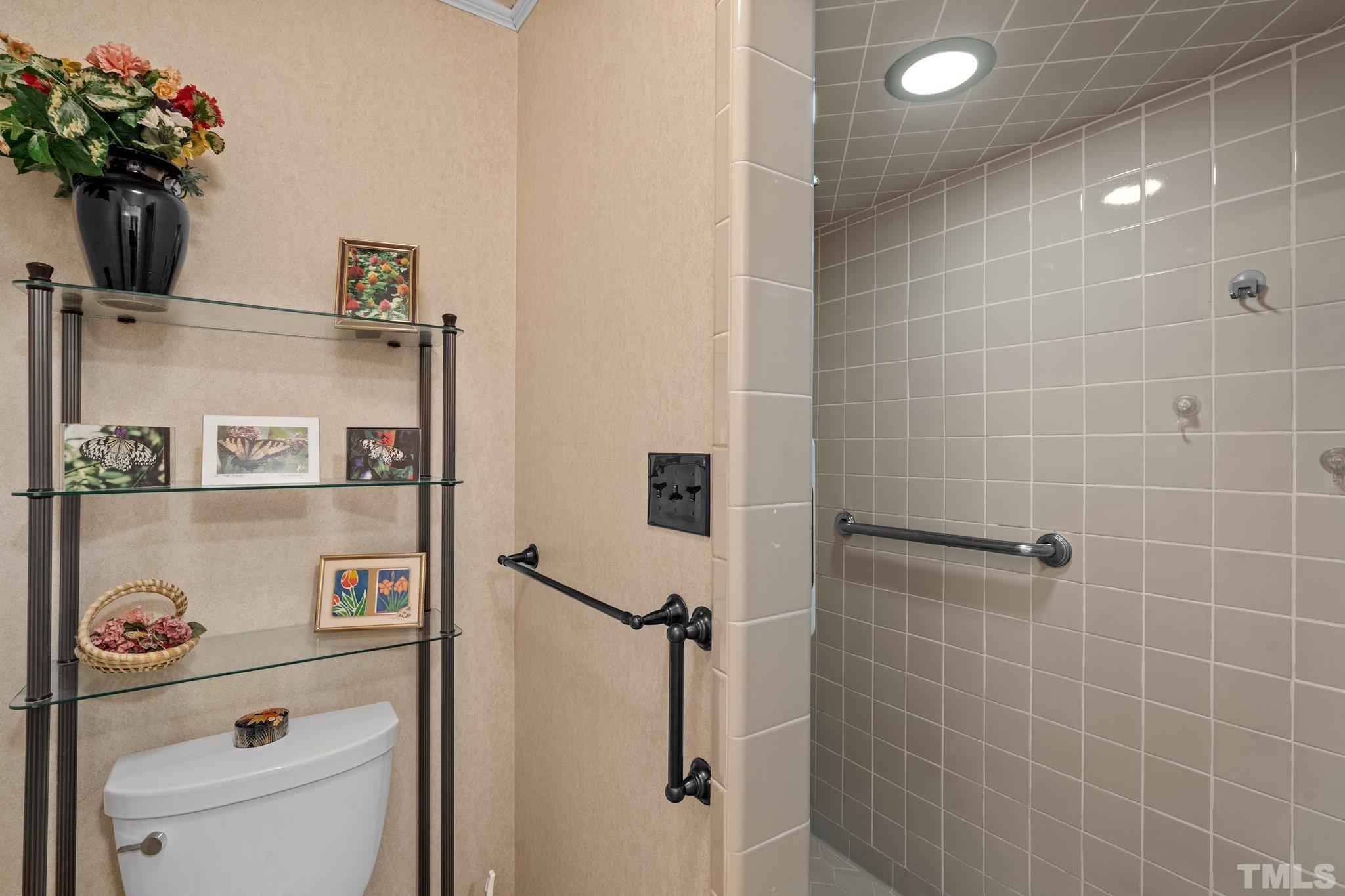 7805 Harps Mill Road Raleigh, NC 27615 - Photo 31 of 57 a bathroom with a shower and a sink