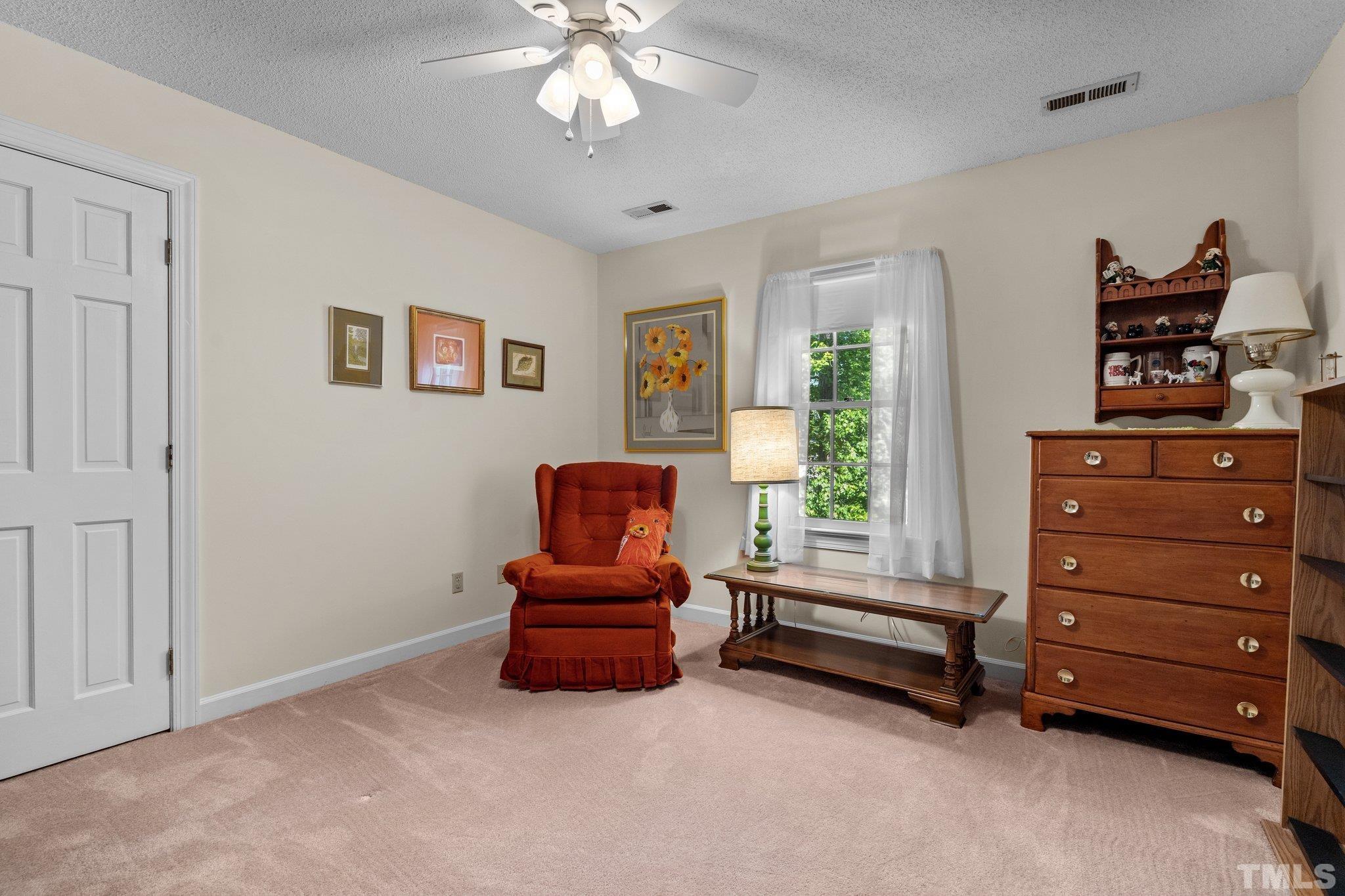 7805 Harps Mill Road Raleigh, NC 27615 - Photo 38 of 57 a living room with furniture and a window