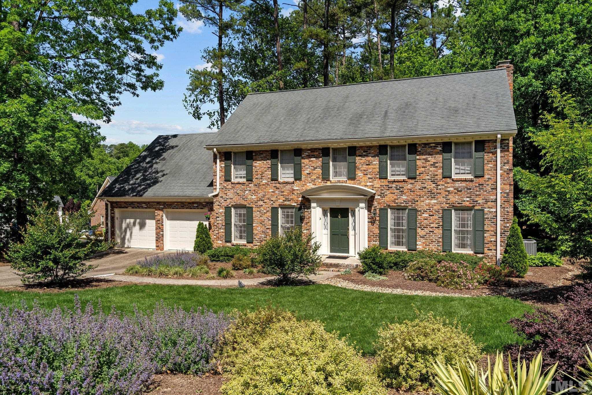 7805 Harps Mill Road Raleigh, NC 27615 - Photo 4 of 57 a front view of a house with a yard