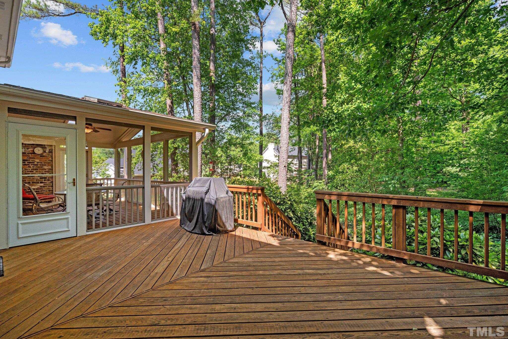 7805 Harps Mill Road Raleigh, NC 27615 - Photo 48 of 57 a view of a deck with a floor to ceiling window next to a yard