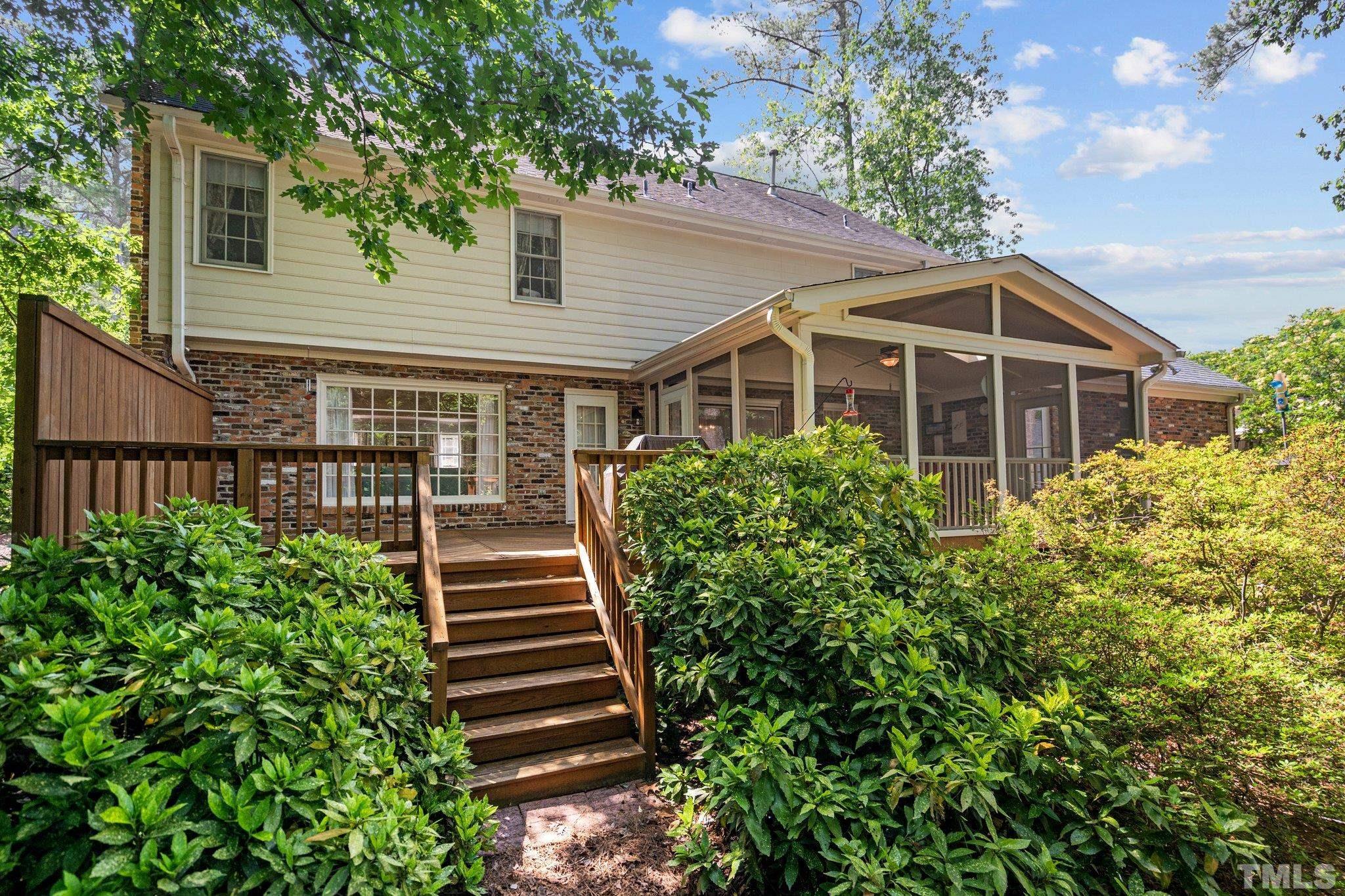 7805 Harps Mill Road Raleigh, NC 27615 - Photo 49 of 57 a view of a house with large windows and a small yard