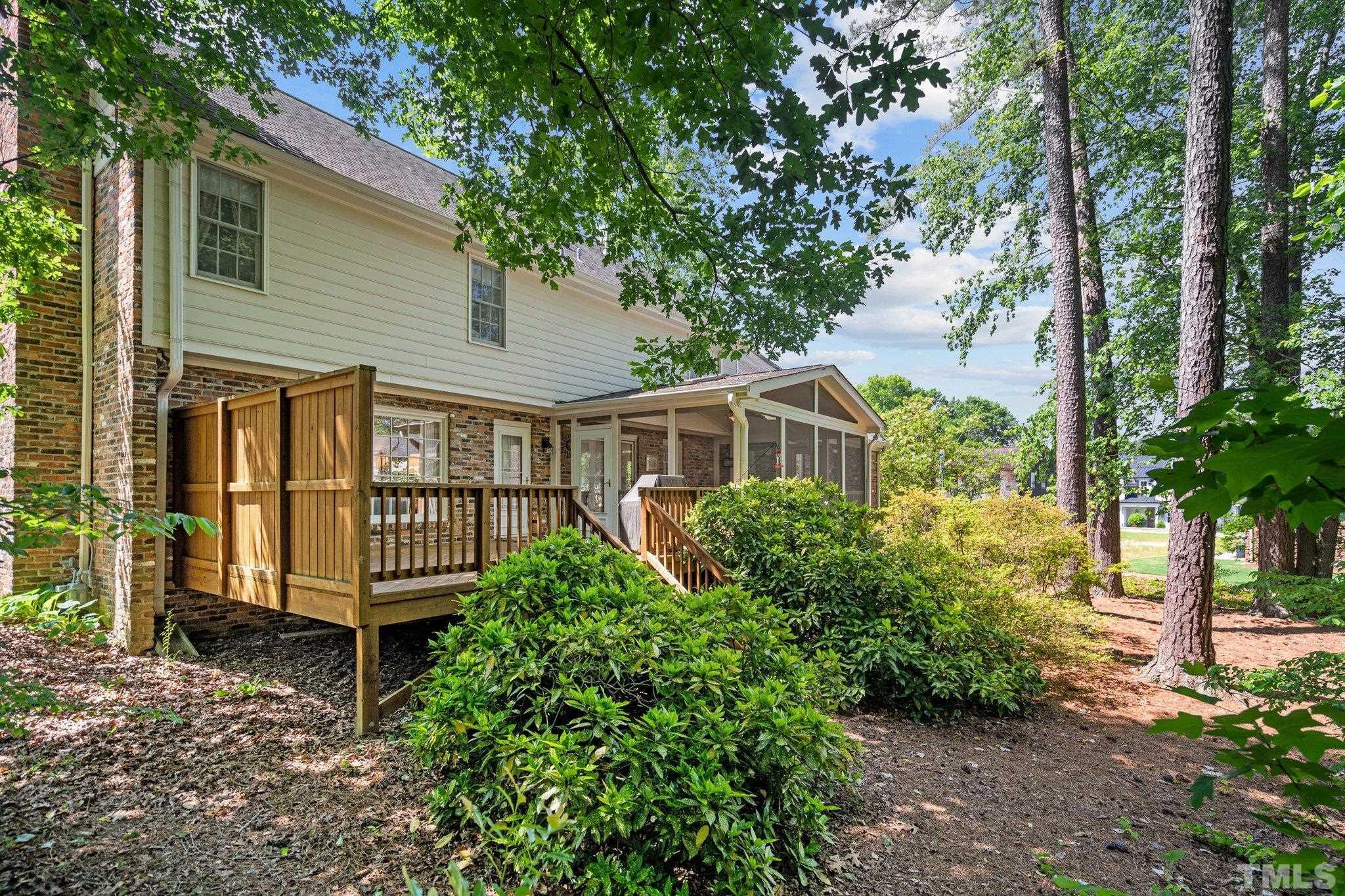 7805 Harps Mill Road Raleigh, NC 27615 - Photo 50 of 57 a front view of a house with plants and garden