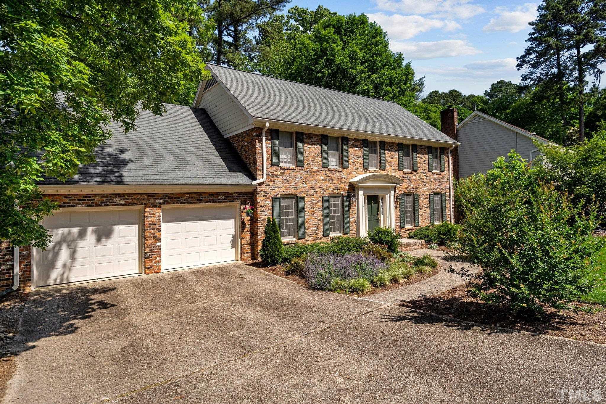 7805 Harps Mill Road Raleigh, NC 27615 - Photo 5 of 57 front view of a house with a yard