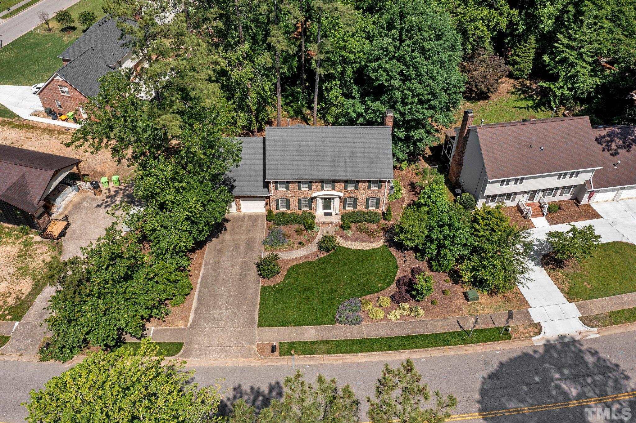 7805 Harps Mill Road Raleigh, NC 27615 - Photo 52 of 57 an aerial view of a house with a garden and yard