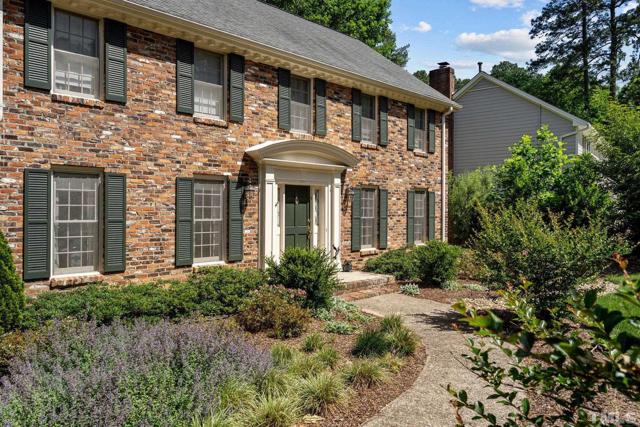 7805 Harps Mill Road Raleigh, NC 27615 - Photo 6 of 57 a front view of a house with garden