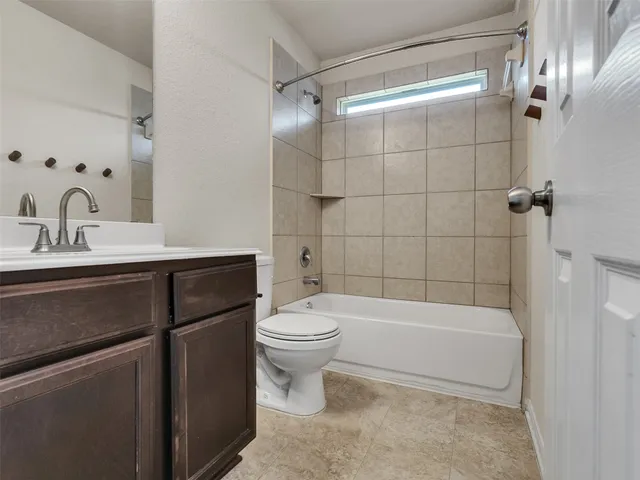 a kitchen with a refrigerator and cabinets