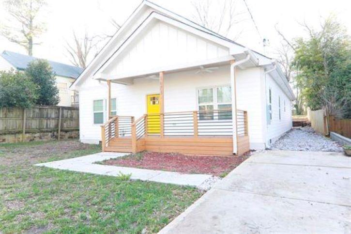 1673 Fairway Drive Mableton, GA 30126 - Photo 2 of 27 a front view of a house with a yard and garage