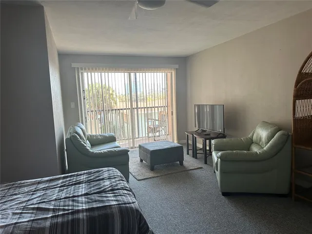 a bedroom with furniture and a large window