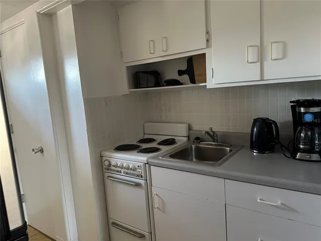 a kitchen with stainless steel appliances granite countertop white cabinets and a stove