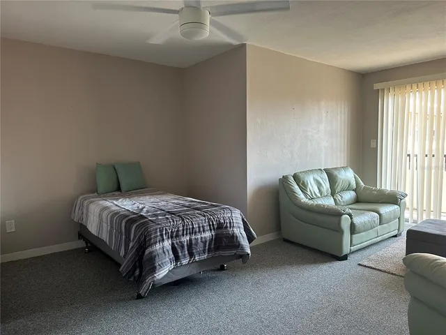 a spacious bedroom with a bed and a couch