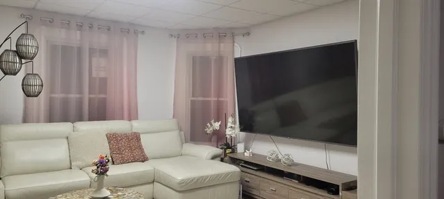 a living room with a couch and a flat screen tv