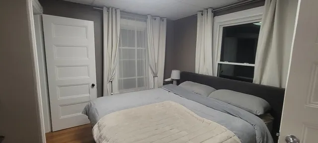 a bedroom with a bed and a mirror