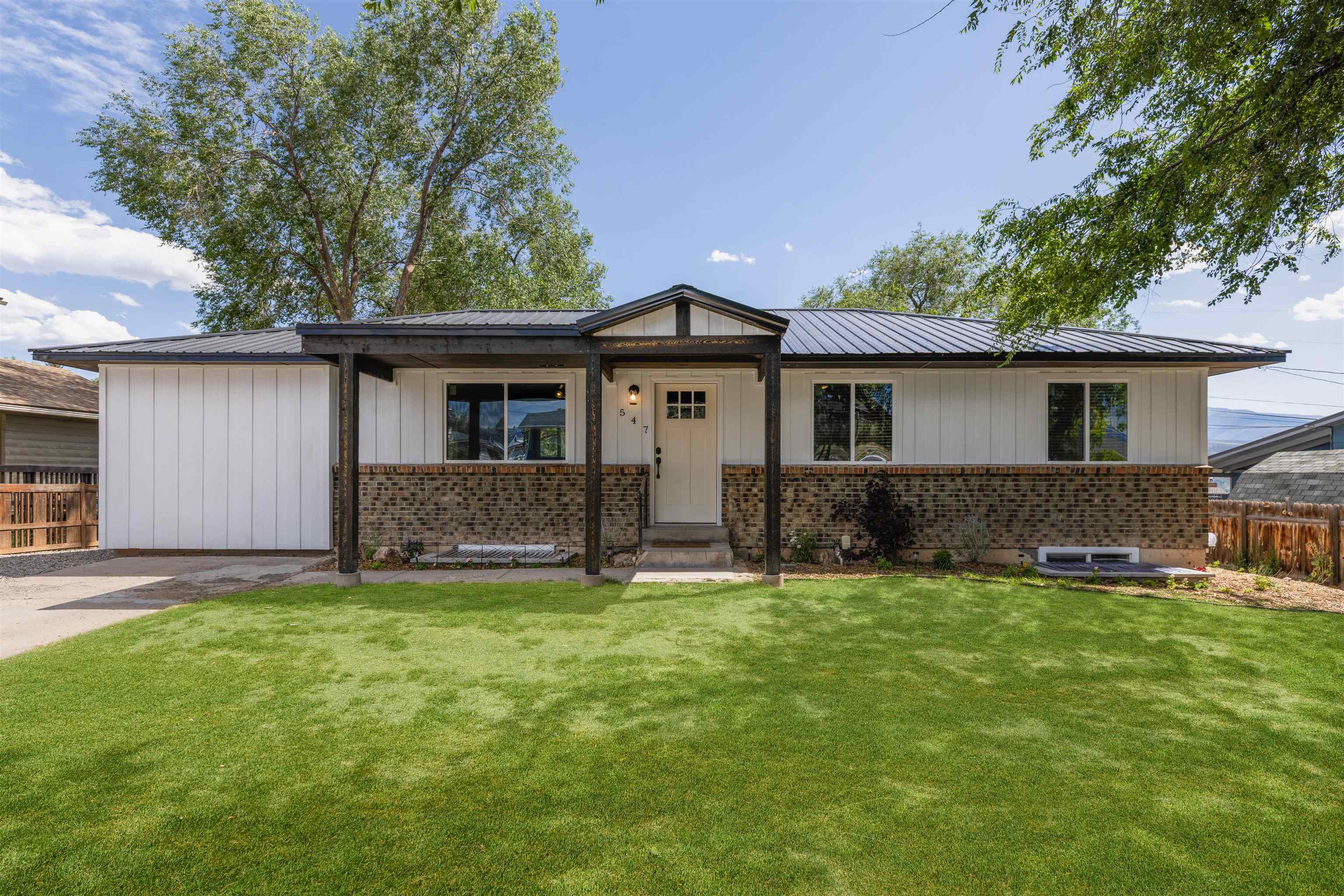 547 East 12th Street Rifle, CO 81650 - Photo 1 of 26 a front view of a house with a yard and garage