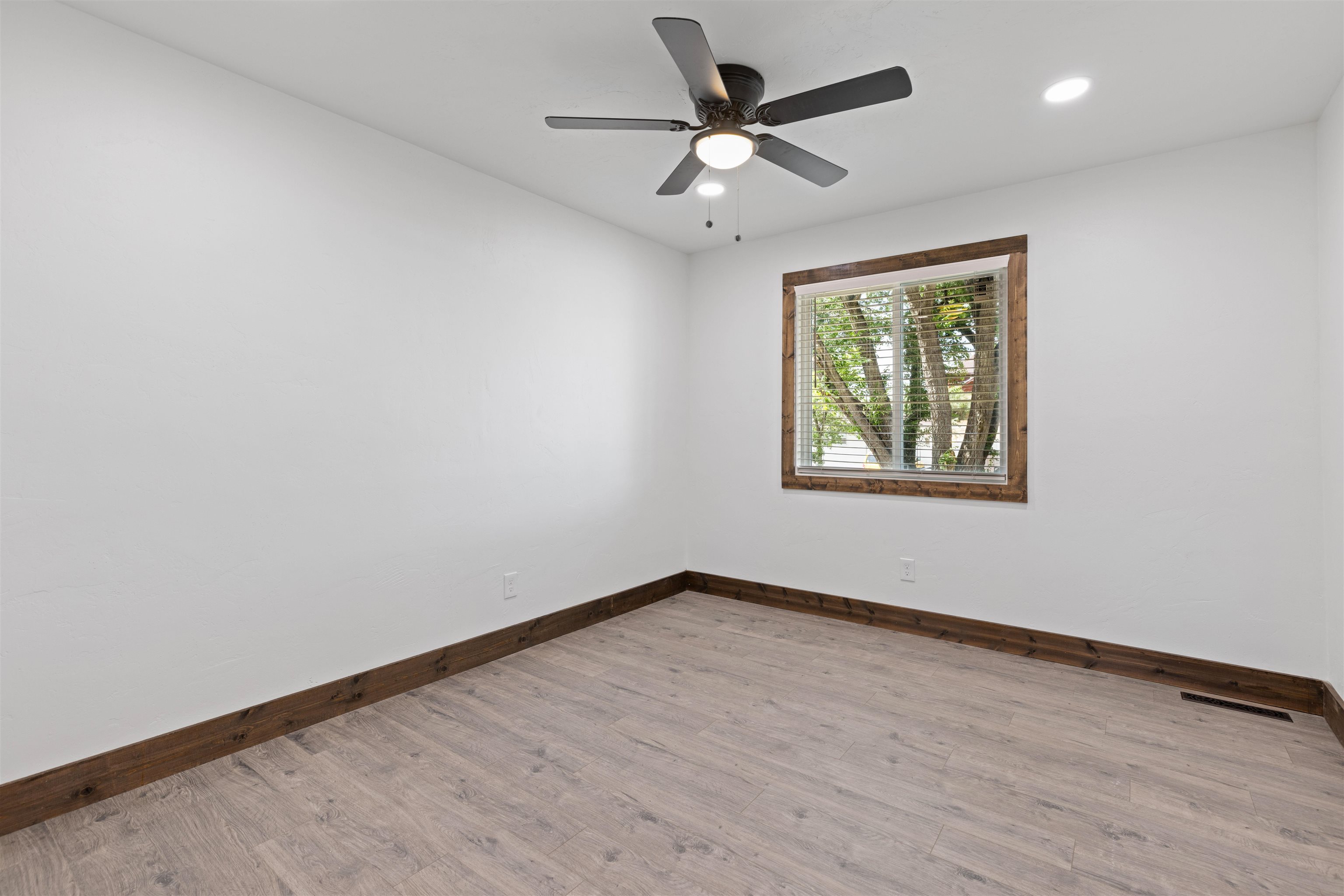 547 East 12th Street Rifle, CO 81650 - Photo 14 of 26 an empty room with wooden floor and windows