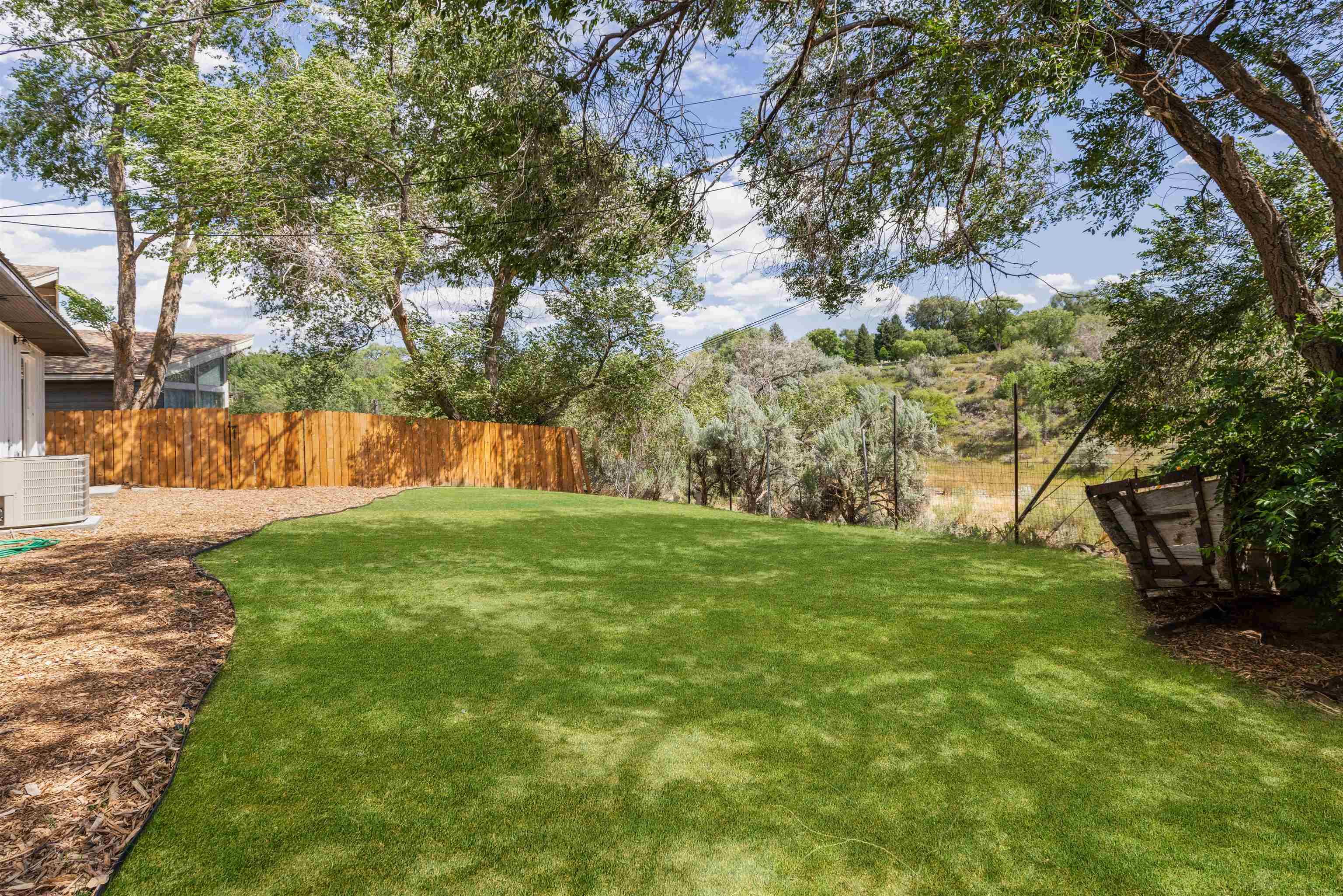 547 East 12th Street Rifle, CO 81650 - Photo 25 of 26 a view of a yard with a tree
