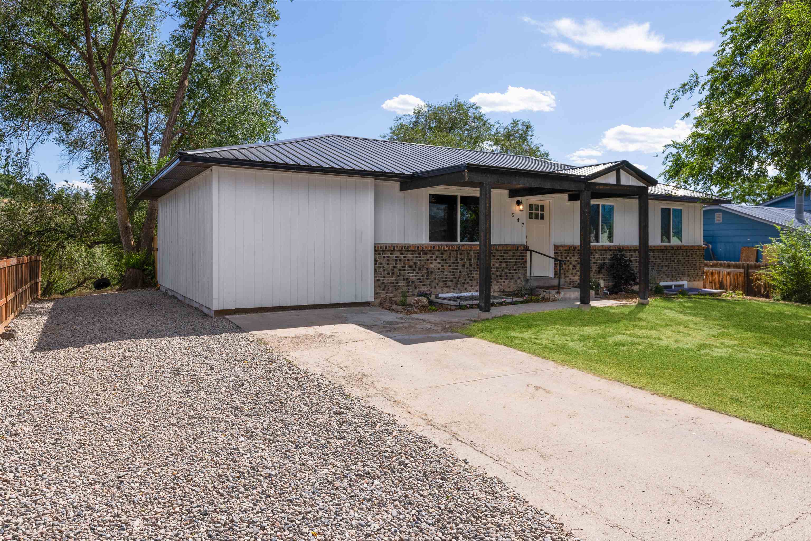 547 East 12th Street Rifle, CO 81650 - Photo 3 of 26 a front view of a house with garden