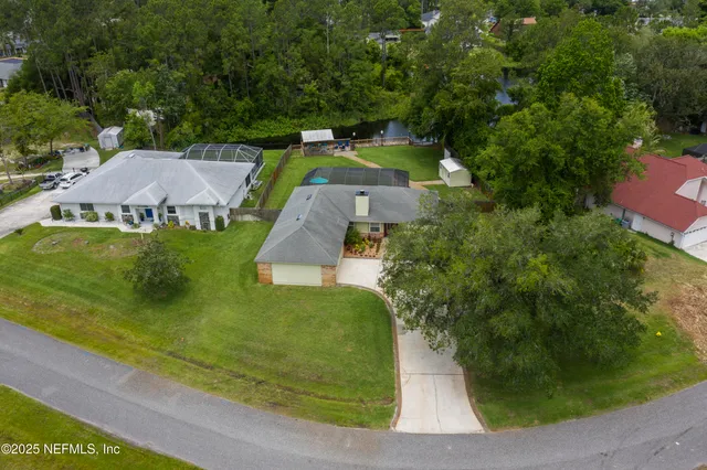 an aerial view of a house with a garden and swimming pool