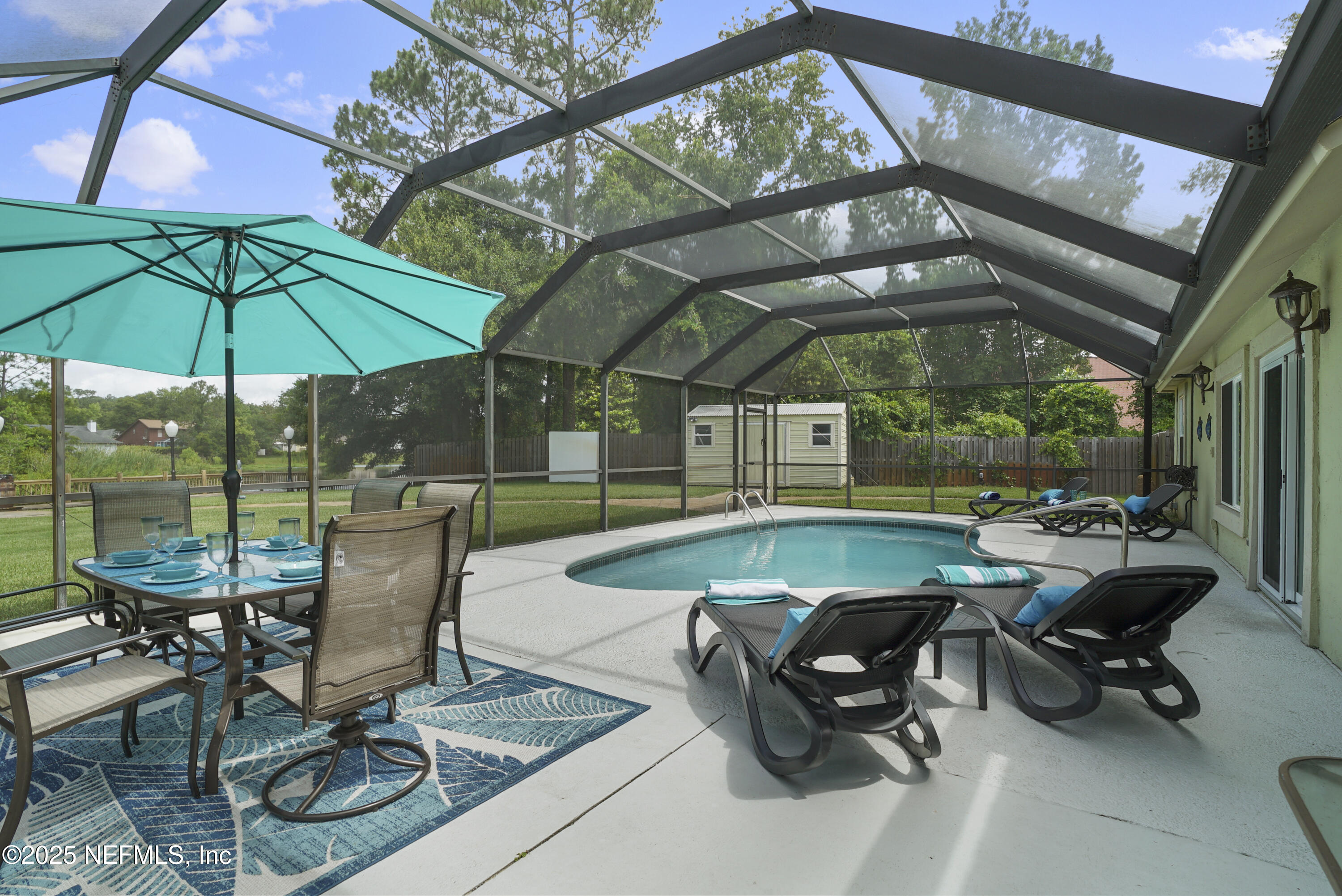 4041 Pine Run Circle St. Augustine, FL 32086 - Photo 17 of 57 a patio with a patio table and chairs