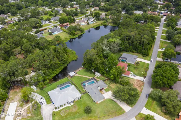 an aerial view of a house with garden space and street view