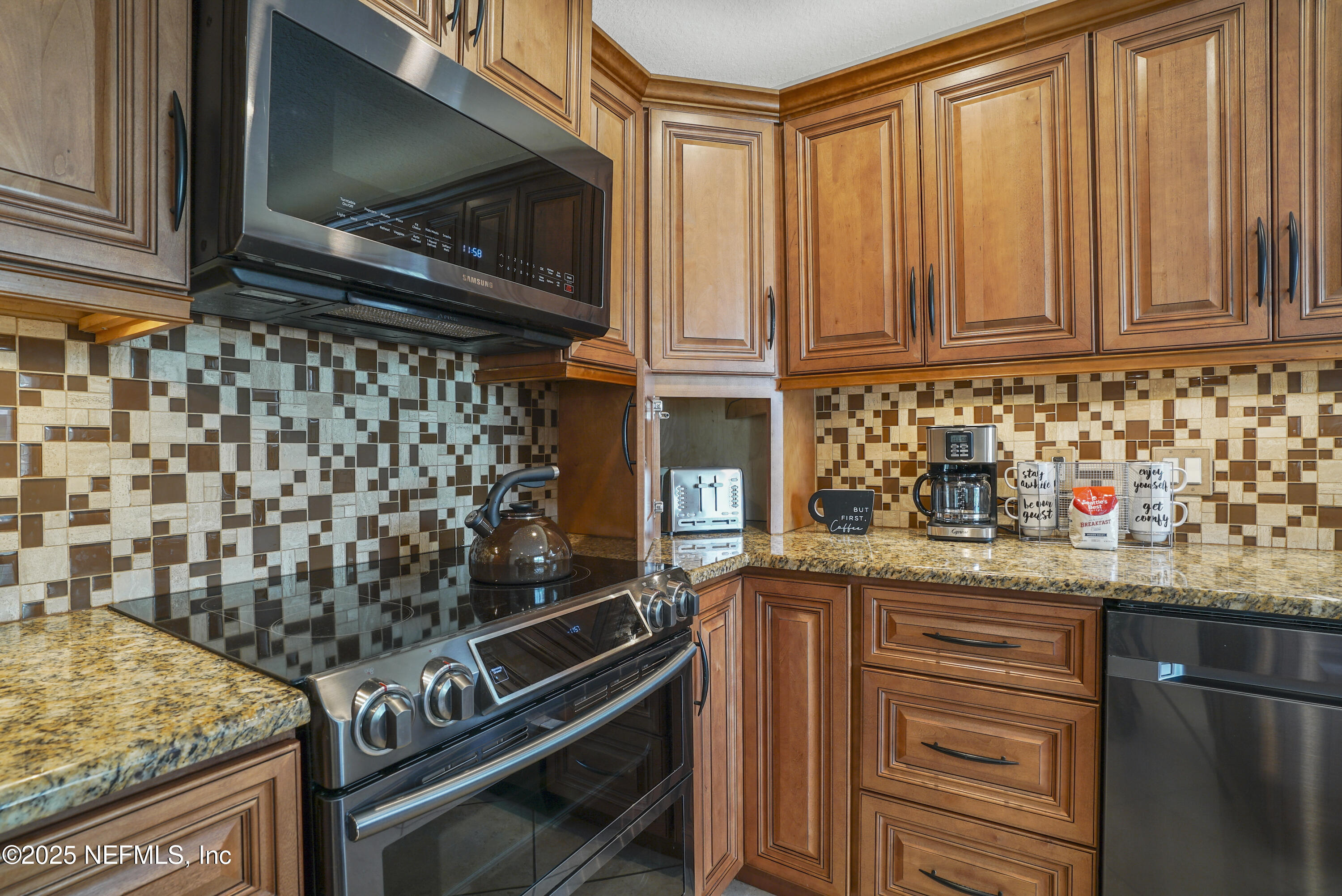 4041 Pine Run Circle St. Augustine, FL 32086 - Photo 34 of 57 a kitchen with stainless steel appliances granite countertop a stove and a microwave