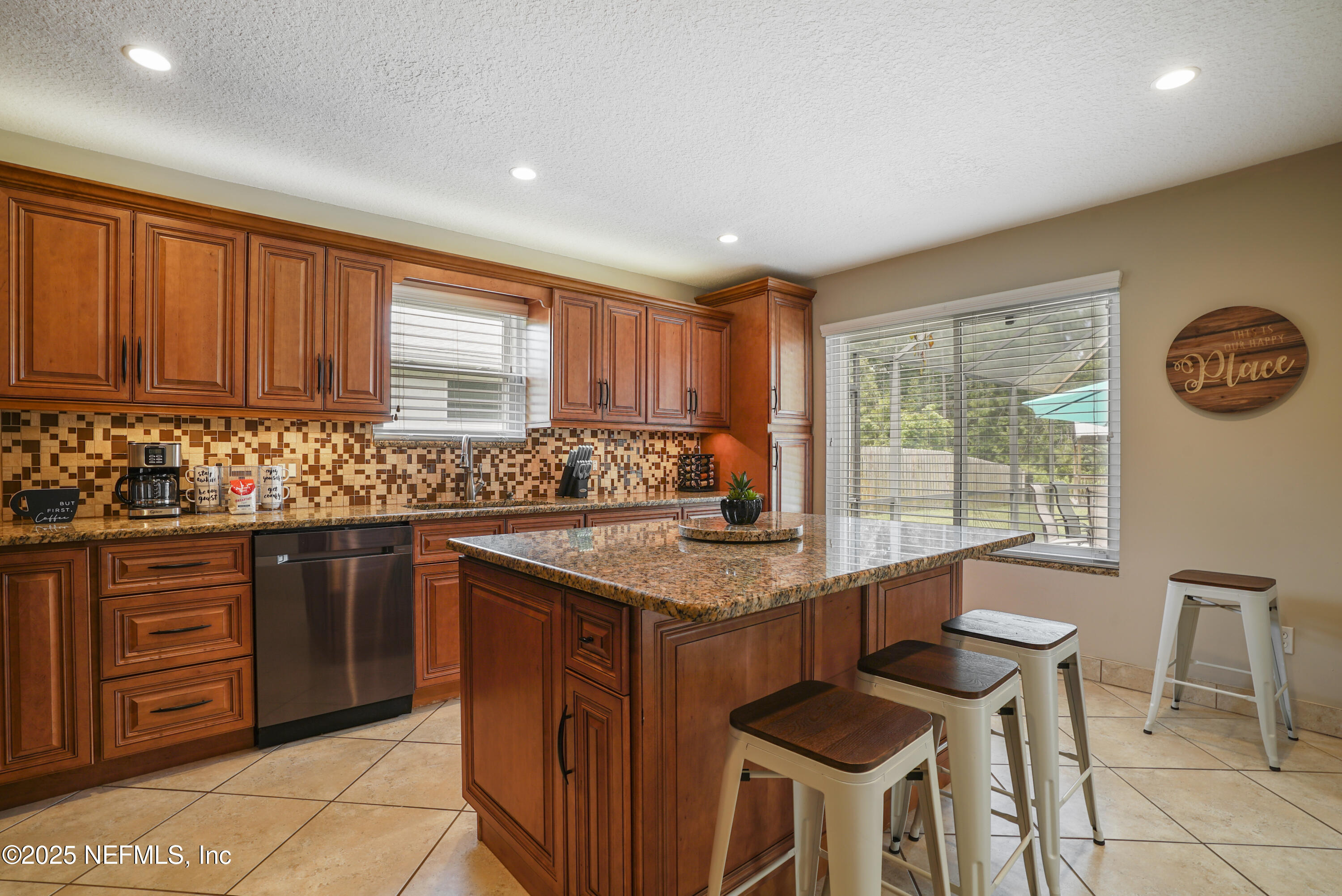 4041 Pine Run Circle St. Augustine, FL 32086 - Photo 35 of 57 a kitchen with stainless steel appliances granite countertop a stove a sink and a refrigerator