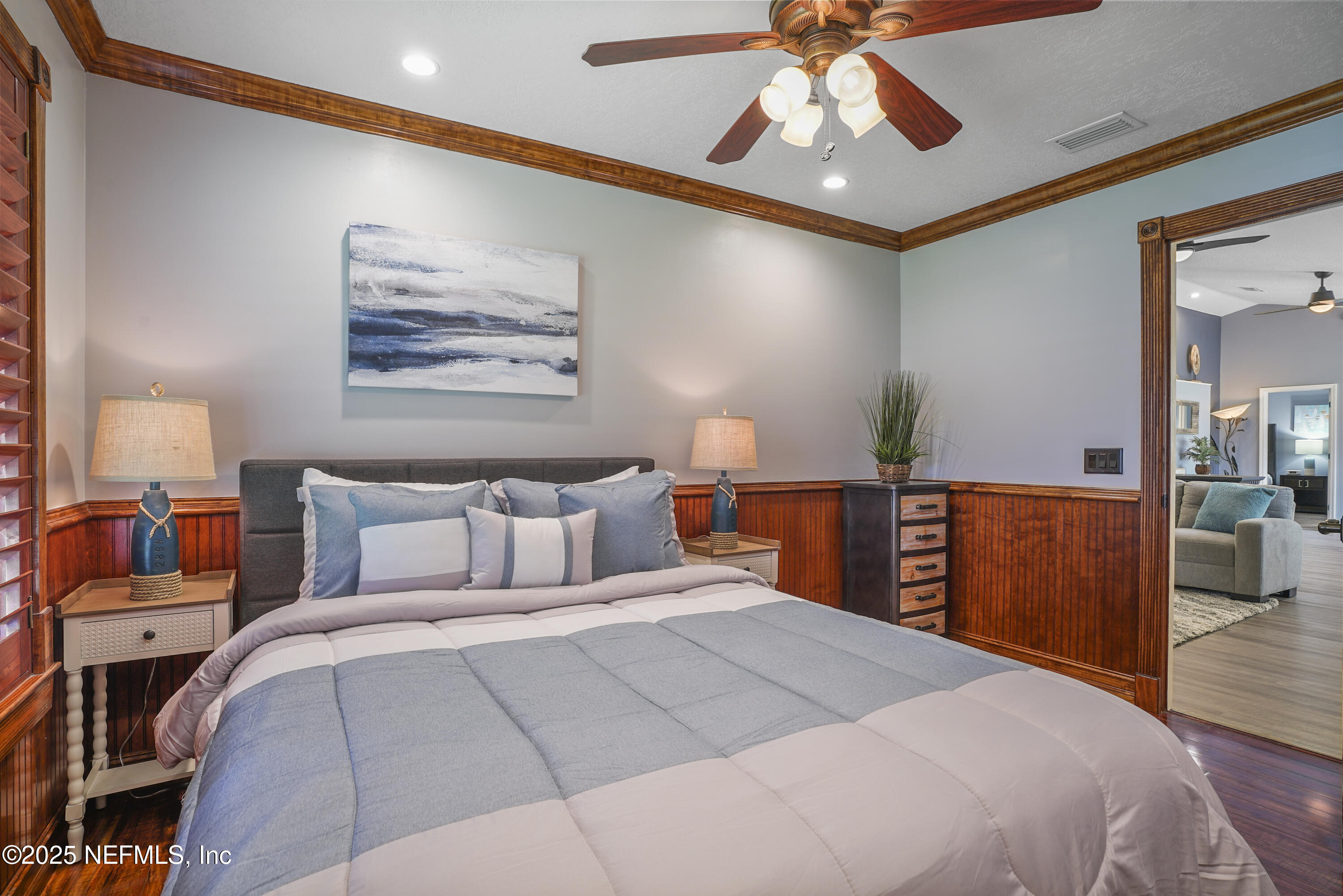 4041 Pine Run Circle St. Augustine, FL 32086 - Photo 45 of 57 a bedroom with a bed and a chandelier