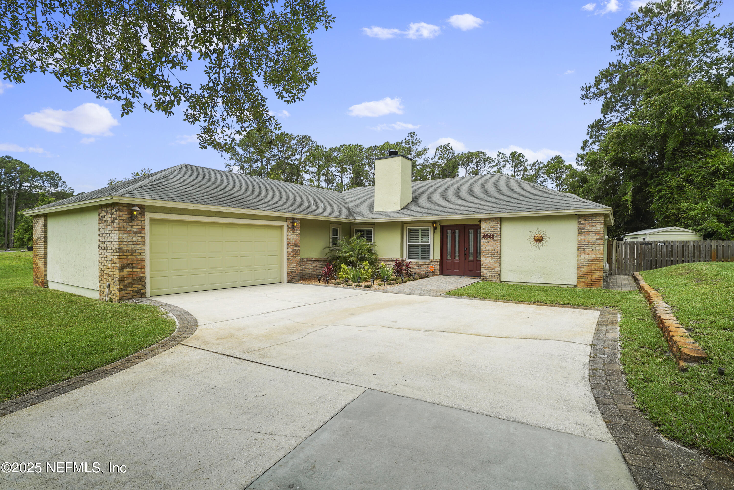 4041 Pine Run Circle St. Augustine, FL 32086 - Photo 54 of 57 a front view of a house with a yard and garage