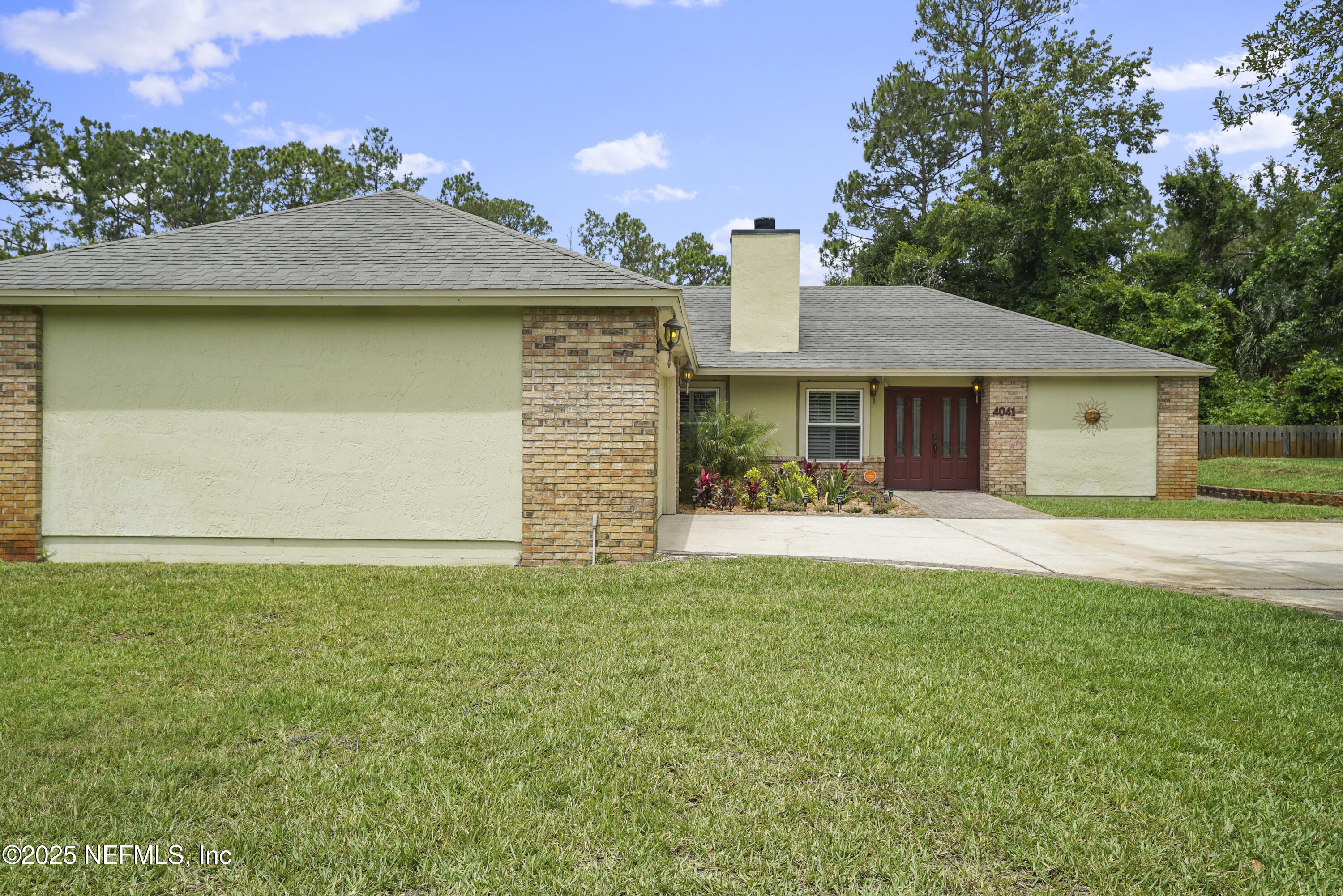 4041 Pine Run Circle St. Augustine, FL 32086 - Photo 56 of 57 a front view of a house with a garden and yard
