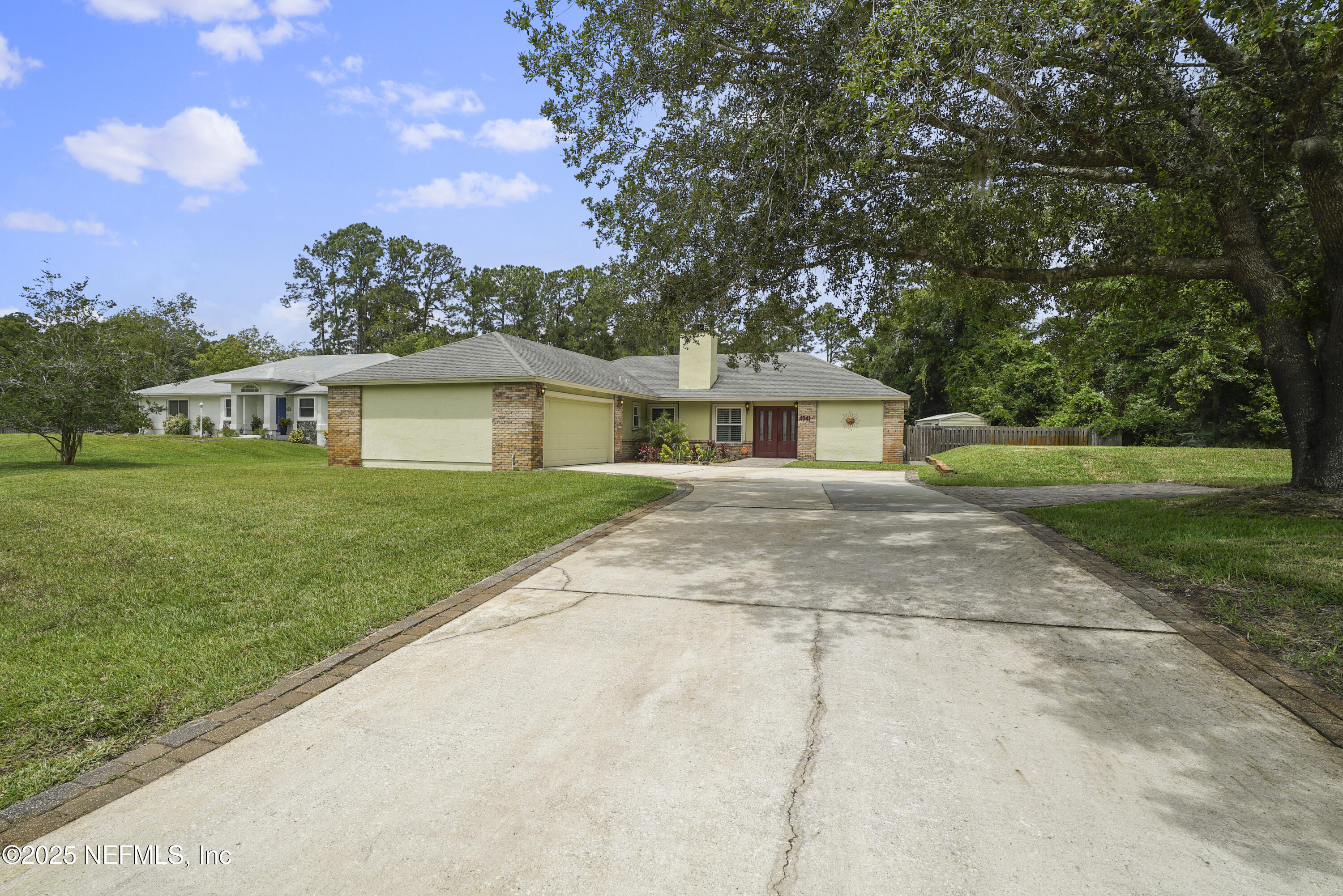 4041 Pine Run Circle St. Augustine, FL 32086 - Photo 57 of 57 a front view of a house with a garden and yard