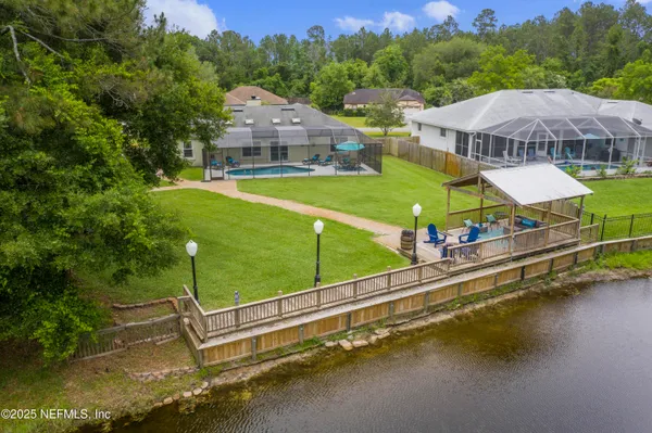 a view of a swimming pool with a garden and trees