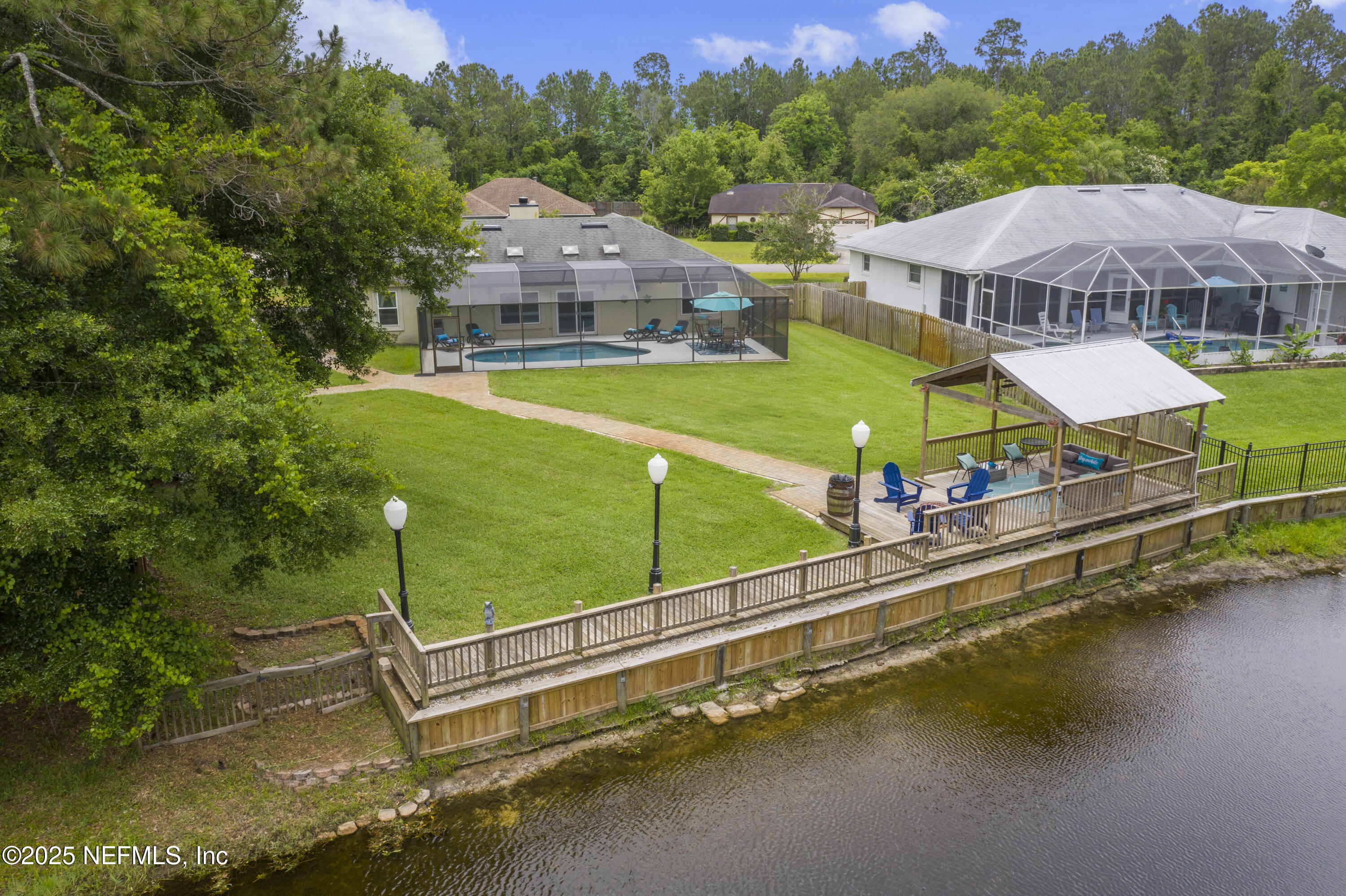 4041 Pine Run Circle St. Augustine, FL 32086 - Photo 6 of 57 an aerial view of a house with swimming pool patio and lake view