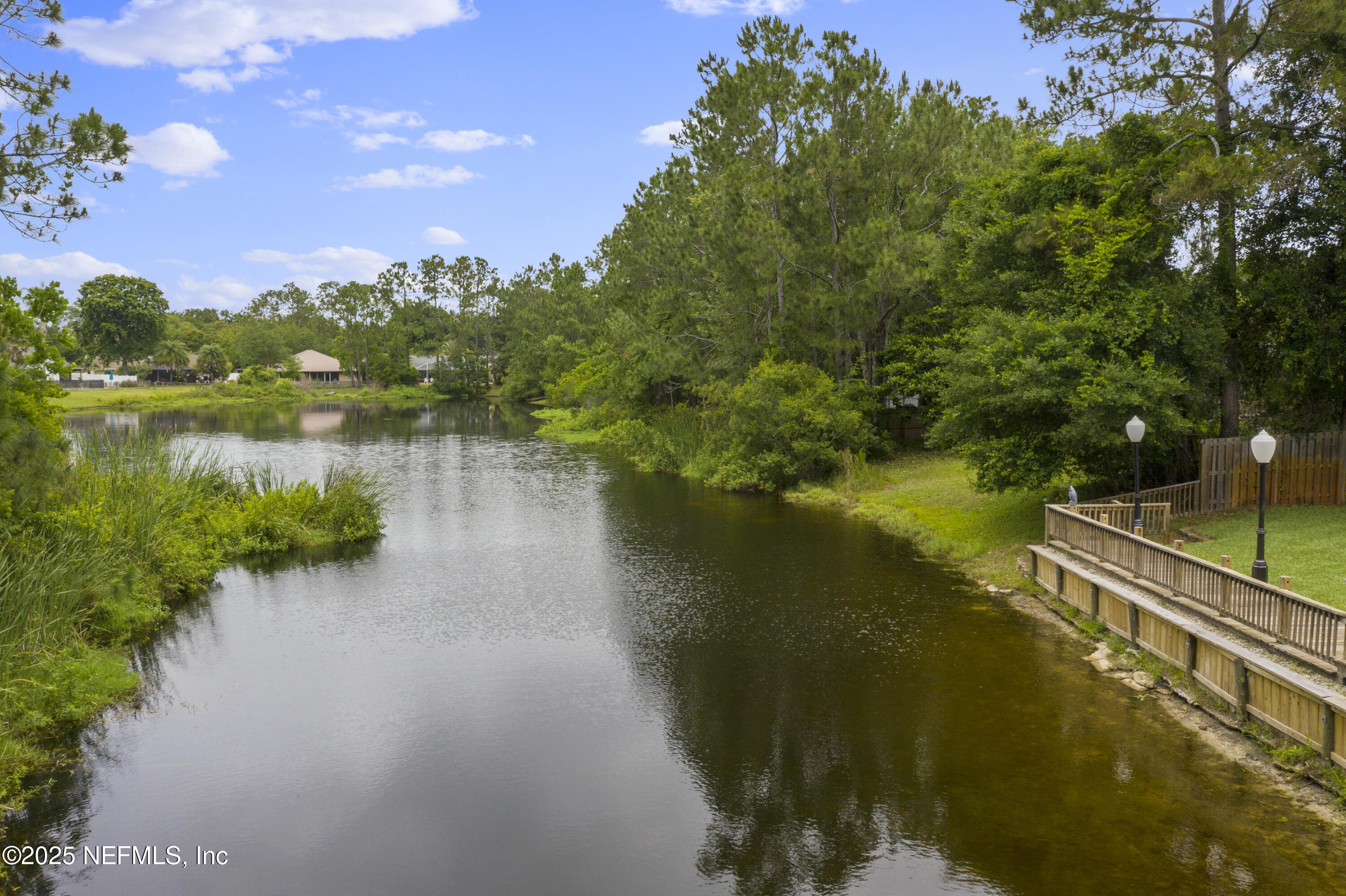 4041 Pine Run Circle St. Augustine, FL 32086 - Photo 8 of 57 a view of a lake with a house in the background