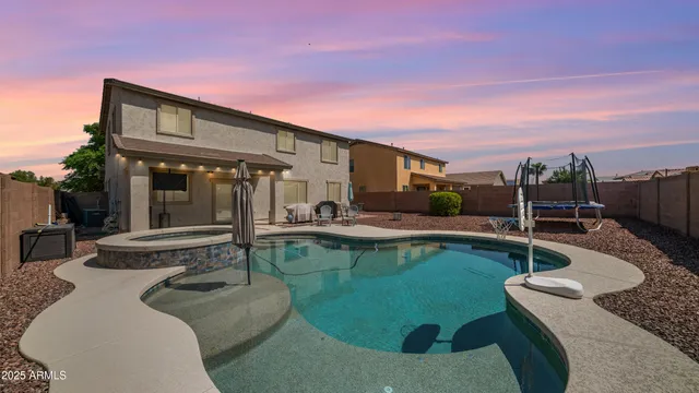 a view of a house with swimming pool and furniture