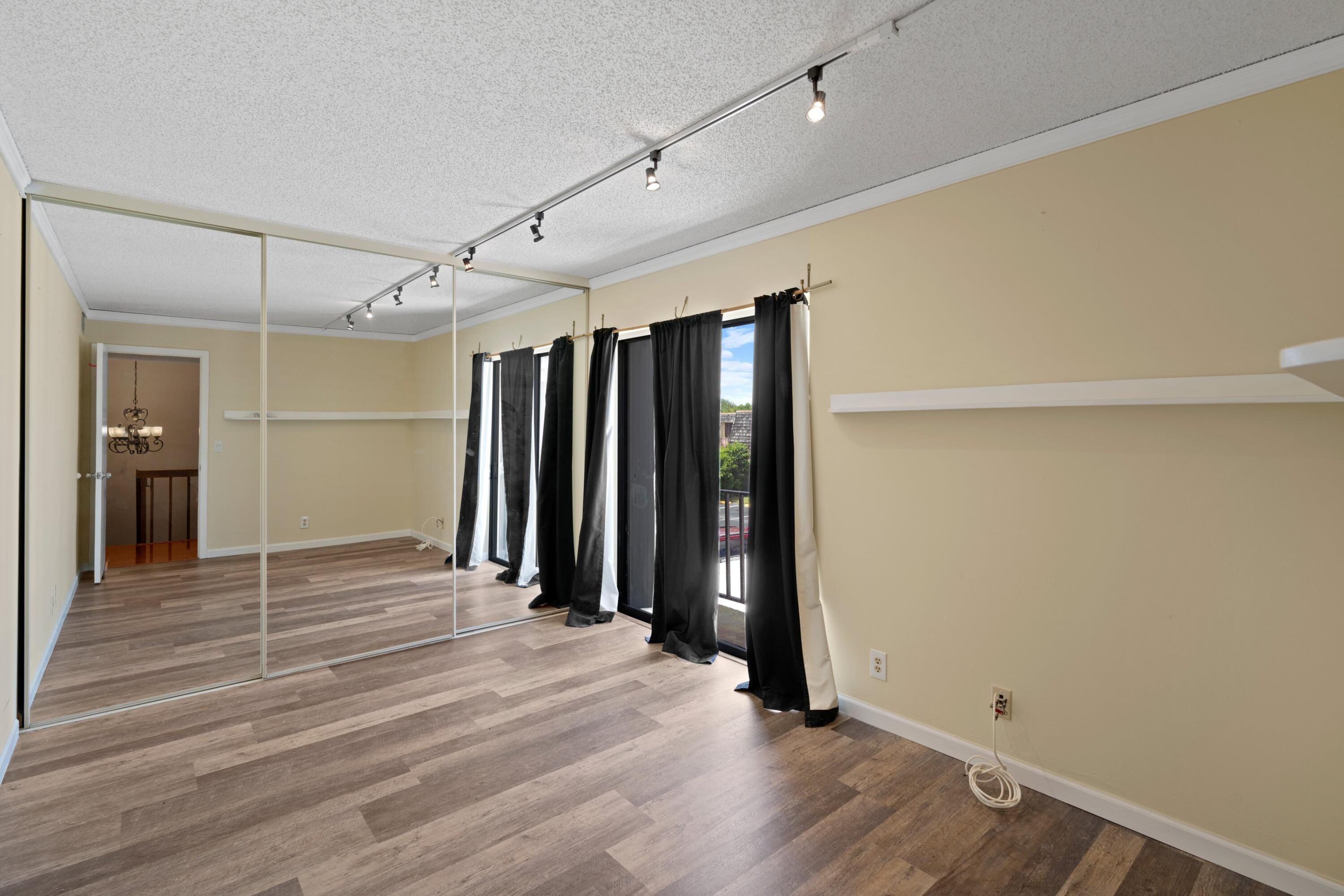 109 Woodland Road Palm Springs, FL 33461 - Photo 15 of 20 wooden floor in an empty room