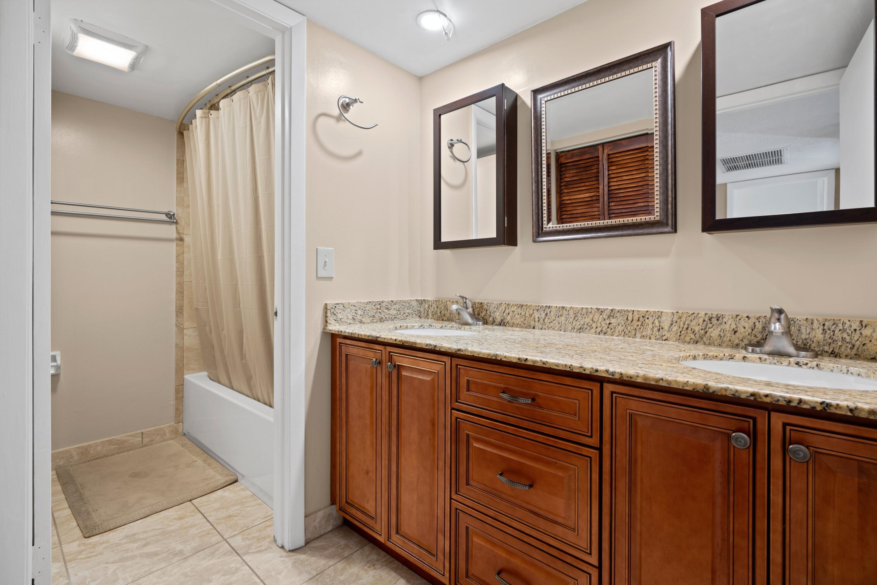 109 Woodland Road Palm Springs, FL 33461 - Photo 16 of 20 a bathroom with a granite countertop sink and a mirror