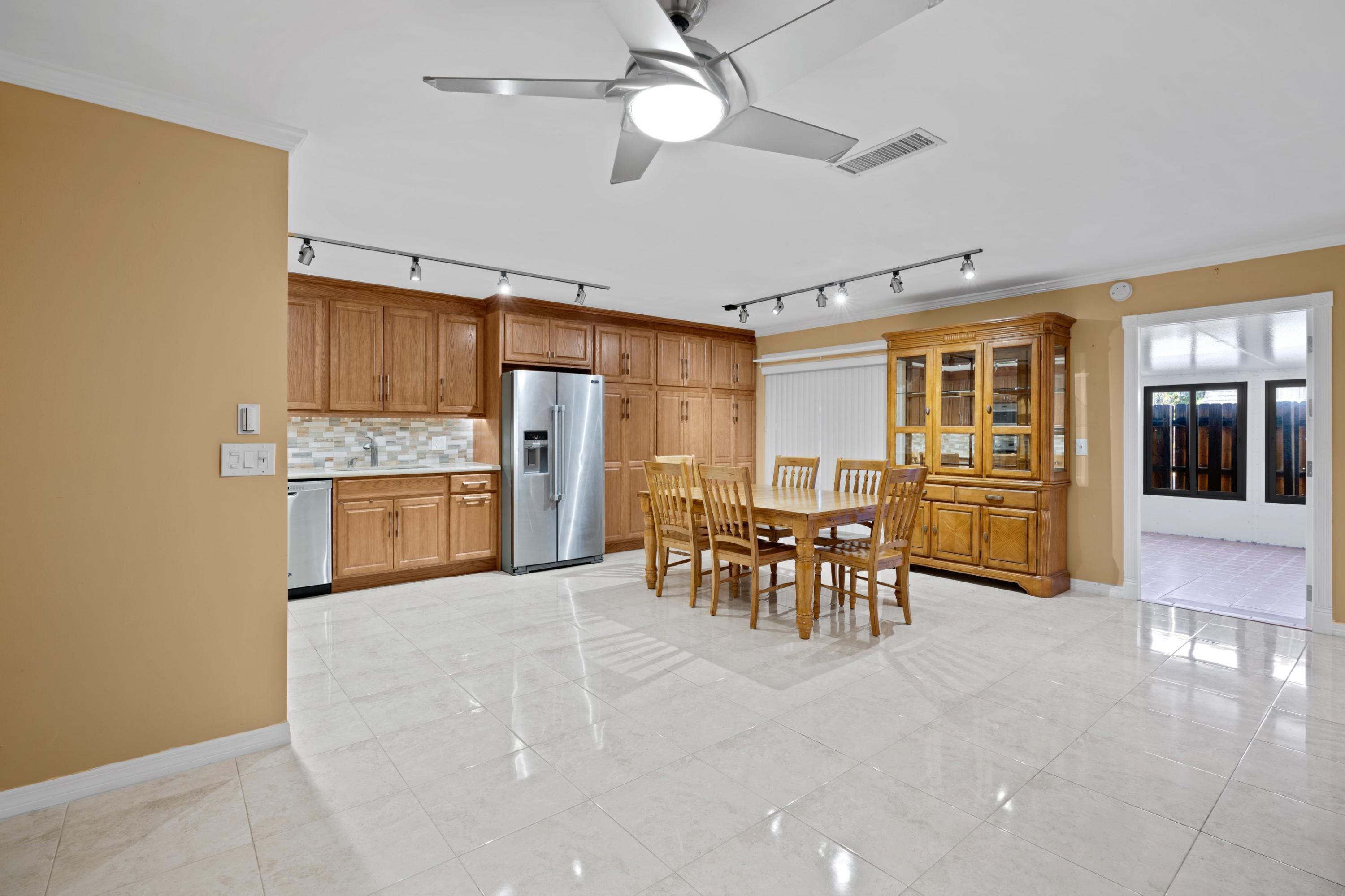 109 Woodland Road Palm Springs, FL 33461 - Photo 8 of 20 a view of kitchen with furniture and refrigerator