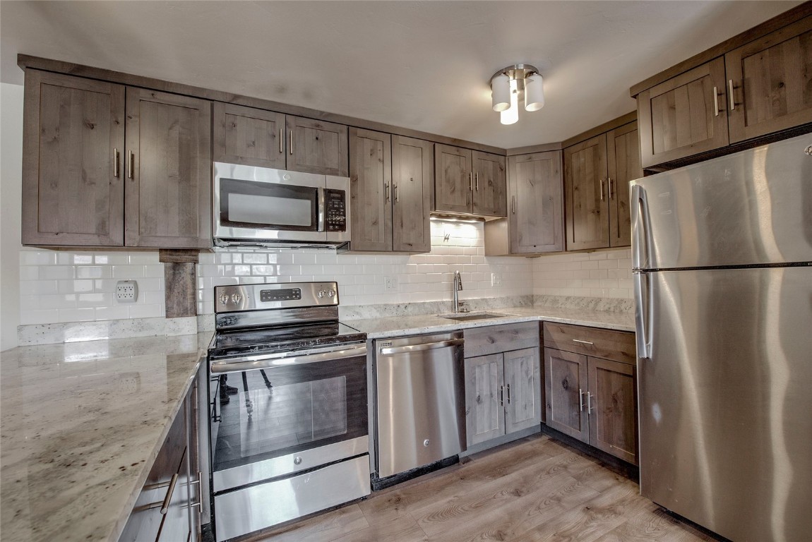 150 Evergreen Road, Unit 106 Dillon, CO 80435 - Photo 1 of 19 a kitchen with a refrigerator stove and microwave