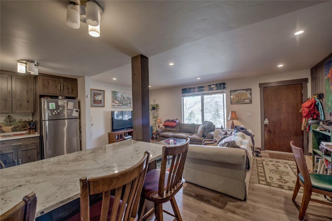 150 Evergreen Road, Unit 106 Dillon, CO 80435 - Photo 18 of 19 a living room with furniture a chandelier and kitchen view