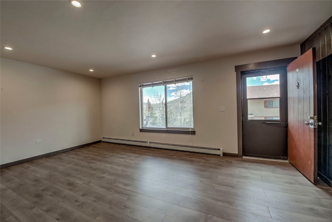 150 Evergreen Road, Unit 106 Dillon, CO 80435 - Photo 5 of 19 an empty room with wooden floor and windows