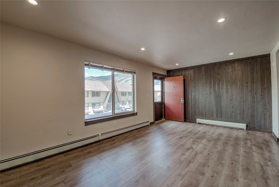 150 Evergreen Road, Unit 106 Dillon, CO 80435 - Photo 6 of 19 an empty room with wooden floor and windows