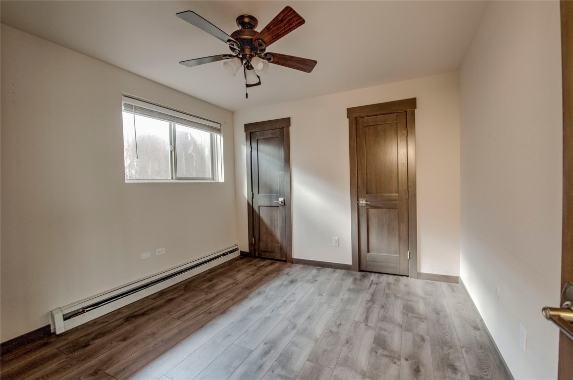 150 Evergreen Road, Unit 106 Dillon, CO 80435 - Photo 7 of 19 an empty room with wooden floor closet and windows