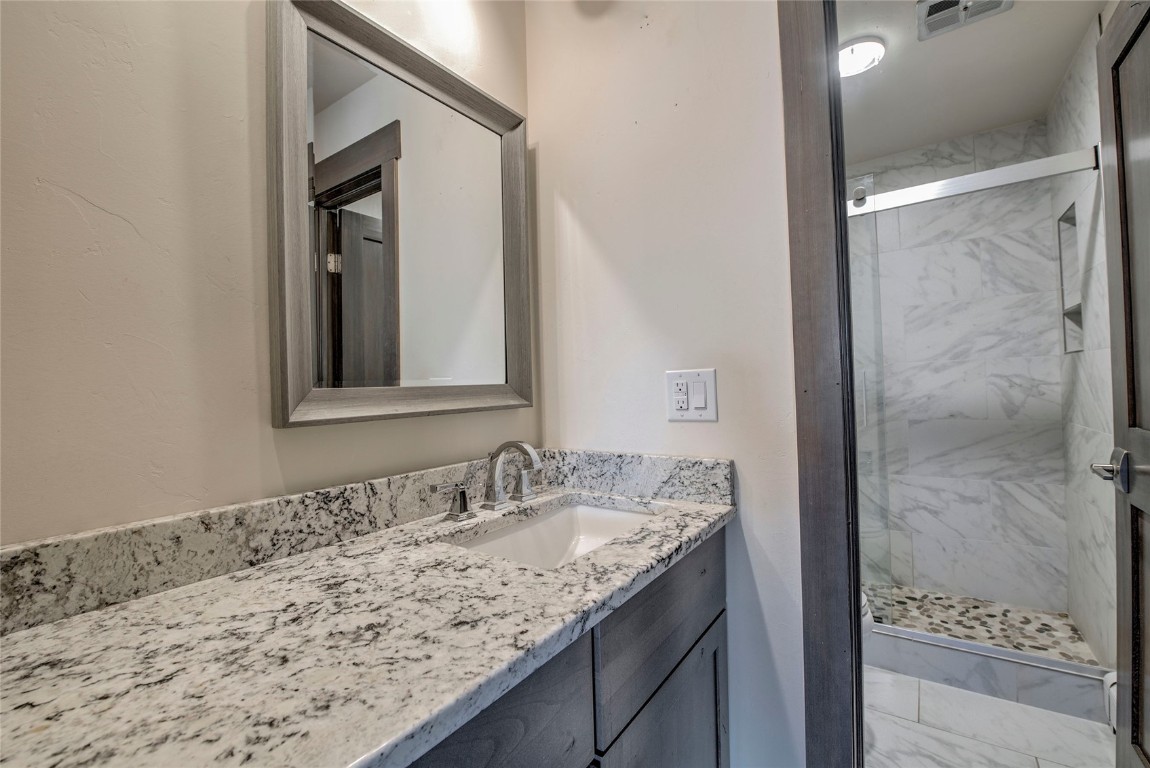 150 Evergreen Road, Unit 106 Dillon, CO 80435 - Photo 8 of 19 a bathroom with a granite countertop sink and a mirror