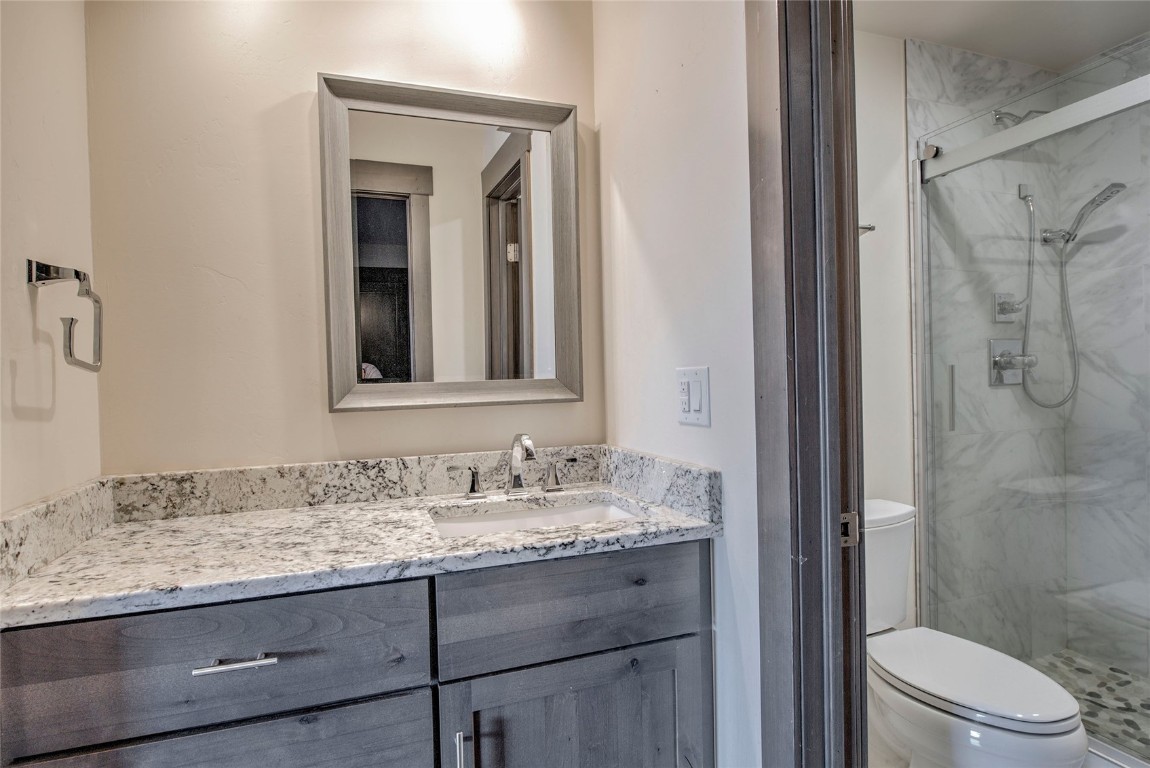 150 Evergreen Road, Unit 106 Dillon, CO 80435 - Photo 9 of 19 a bathroom with a granite countertop sink toilet and shower