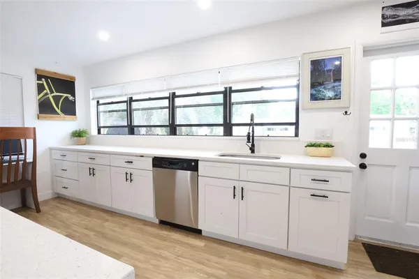 a kitchen with cabinets and stainless steel appliances